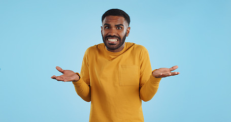 Image showing Confused, hands and face of man in studio with dont know, gesture or ask on blue background. Why, portrait and guy model with oops, mistake or doubt, unsure or forget, guess or palm scale questions