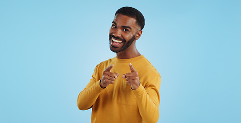 Image showing Face, excited and black man pointing at you for decision, choice or selection in studio isolated on a blue background mockup space. Portrait, hand gesture and person hiring, recruitment or invitation