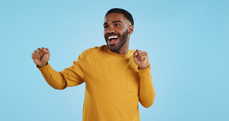 Image showing Dance, man and excited for party in studio to celebrate success, promotion and winning lotto on blue background. Happy young model, giveaway winner and energy for disco, groovy music and freedom