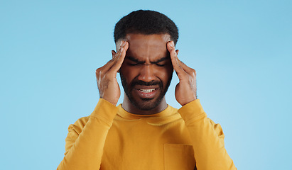 Image showing Stress, tired and a man with headache pain on a blue background from burnout or anxiety. Mental health, fatigue and a person with a migraine massage, frustrated and with depression and anger