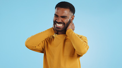 Image showing Neck pain, stress and man in studio frustrated with arthritis, tension or pressure on blue background. Shoulder, anxiety and face upset male model with burnout, osteoporosis or fibromyalgia injury