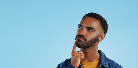 Image showing Man, thinking and planning idea with decision and choice in studio on blue background and questions. Brainstorming, person and problem solving ideas or why with solution and remember on mock up space