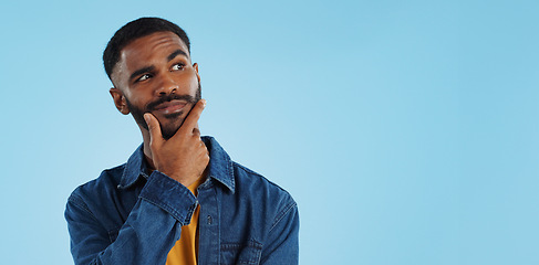 Image showing Man, thinking and planning idea with choice and decision in studio on blue background and questions. Brainstorming, person and problem solving ideas or why with solution and remember on mock up space