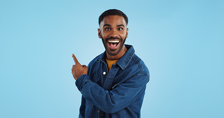 Image showing Advertising studio smile, man and pointing at ads commercial, retail information or discount announcement. Sales info, mockup space and portrait person show service, deal or news on blue background