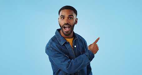 Image showing Advertising studio smile, man and pointing at ads commercial, retail information or discount announcement. Sales info, mockup space and portrait person show service, deal or news on blue background