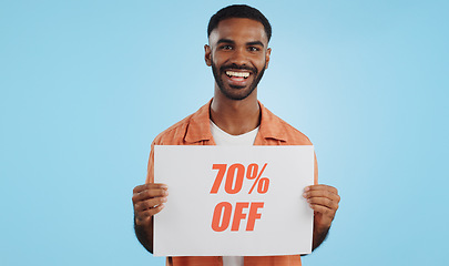 Image showing Discount, sign and promotion, man and portrait, show information and smile isolated on blue background. Poster, billboard or banner with sale news, announcement on board with advertising in studio