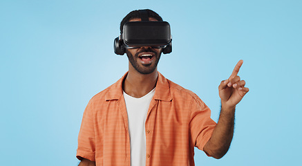 Image showing Man, virtual reality and glasses in studio with hand, click and swipe with smile for metaverse by blue background. Person, AR vision and futuristic game with 3D user experience, cyber ui and esports