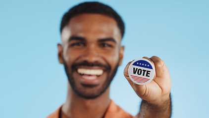 Image showing Vote pin, man and face with badge for politics, government and voting register for election. Studio, blue background and voter choice with administration decision with a smile and happy from support