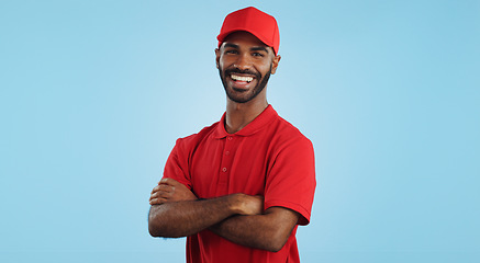 Image showing Delivery man, arms crossed in portrait and e commerce, distribution with supplier and service on blue background. Professional, supply chain and logistics worker for shipping and courier in studio