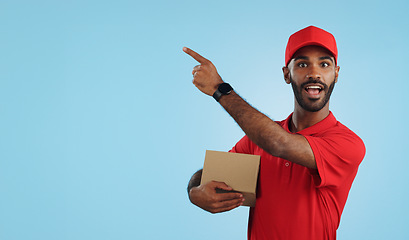 Image showing Advertising studio smile, delivery man and point at supply chain commercial, discount export info or distribution schedule. Courier service deal, mockup space and portrait person on blue background