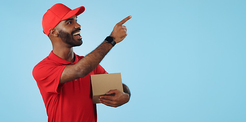 Image showing Advertising studio smile, delivery man and point at supply chain commercial, discount export info or distribution schedule. Courier service deal, mockup space and portrait person on blue background
