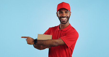 Image showing Advertising studio smile, delivery man and point at supply chain commercial, discount export info or distribution schedule. Courier service deal, mockup space and portrait person on blue background