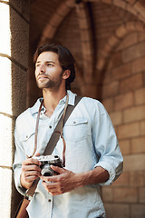 Image showing Relax, photographer or man thinking in brick building on holiday, vacation or weekend trip for an adventure in Italy. Tourist, city travel or person with camera sightseeing in urban town on journey