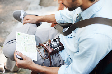 Image showing Man, photographer and camera with map outdoor for travel, direction or location for explore in nature. Person, photography or paper on bench for adventure, journey or tourist with exploration or trip