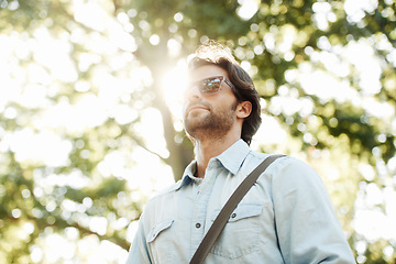 Image showing Relax, sunglasses or man in park walking in summer for fresh air, holiday vacation or break in garden in Italy. Tourism, thinking or male person in nature or natural environment for travel