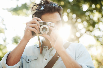 Image showing Camera, photography or man shooting in park on holiday vacation trip for creativity or tourism memory. Photographer, travel or male tourist with pictures for sightseeing or trees in nature in summer