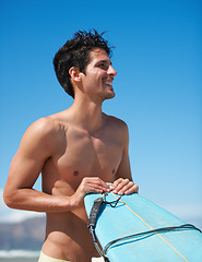 Image showing Surfing, fitness and body happy man at a beach with surfboard for training, freedom or fun. Smile, adventure and male surfer at the sea for water sports, travel or vacation, holiday or summer hobby