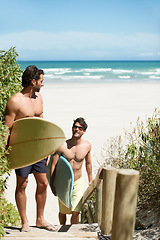 Image showing Beach, fitness and men surfer friends at sea bonding, walking or having fun in nature. Ocean, sports and people with surfboard outdoor for training, freedom or summer vacation workout in South Africa