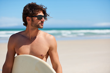 Image showing Man tinking, surf and travel with sunglasses by the beach and sea for fitness and water sport with mockup space. Confidence, male person and surfboard for workout and training by ocean with freedom