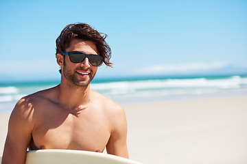 Image showing Man smile, surf and vacation with sunglasses by the beach and sea for fitness and water sport with mockup space. Confidence, male person and surfboard for workout and training by ocean with freedom