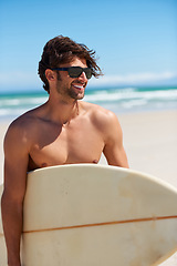 Image showing Happy man, surf and vacation with sunglasses by the beach and sea for fitness and water sport with mockup space. Confidence, male person and surfboard for workout and training by ocean with freedom