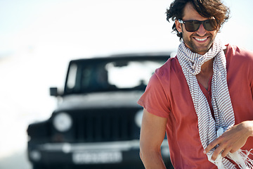 Image showing Sunglasses, portrait and happy man in desert for road trip with freedom, travel and adventure for summer vacation. Transport, holiday journey and driver at van with nature, sunshine and countryside.