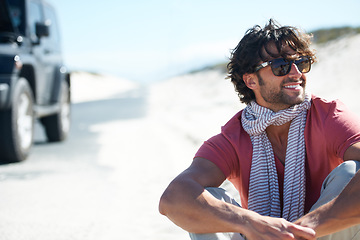 Image showing Smile, happy man sitting in desert and road trip with freedom, car travel and adventure for summer vacation. Transport, holiday journey and smile, person with van in road nature, sunshine and relax.