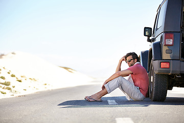 Image showing Problem, desert and man at car on road trip with emergency, travel and desert adventure for vacation. Transport, stress on journey and driver waiting on floor at van with breakdown, suv and relax.