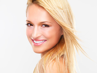 Image showing Portrait, hair and smile with a natural woman in studio on a white background for luxury or keratin treatment. Face, beauty and makeup with a happy young model at the spa or salon for dermatology