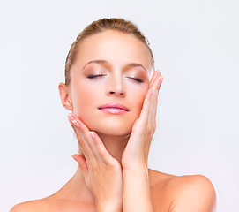 Image showing Woman, makeup and touch face for beauty, skincare treatment and salon glow in studio on white background. Model, facial wellness and healthy benefits for dermatology, cosmetics and aesthetic shine