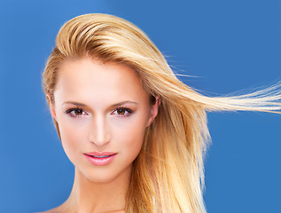 Image showing Portrait, shampoo and wind in the hair of a woman closeup in studio on a white background for natural wellness or cosmetics. Face, beauty and skincare with a young model at the salon for keratin