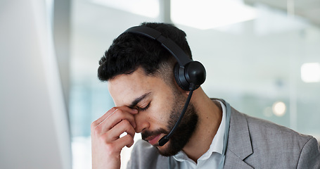 Image showing Stress, headache and man in call center, tired and fatigue at help desk in office. Burnout, anxiety and sales agent in telemarketing frustrated with customer crisis, work mistake and fail challenge