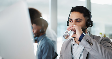 Image showing Happy businessman, call center and drinking water in customer service or telemarketing at office. Thirsty man, consultant or agent talking with headphones and drink for online advice, support or help