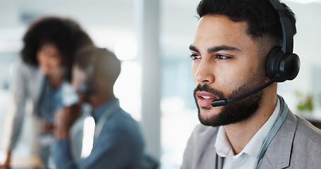 Image showing Call center, face or man speaking in CRM, telemarketing or telecom office for online customer services. Microphone headset, computer or sales agent in tech support help desk for consulting or talking