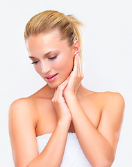 Image showing Spa, beauty and cleaning with a woman in a towel in studio on a white background for natural wellness or cosmetics. Body, skincare or hygiene with a fresh young model after shower for dermatology