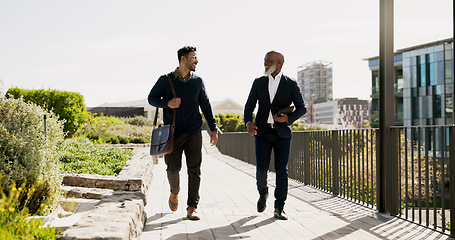 Image showing Walking, outdoor and business people with tablet, support and connection with planning, teamwork and partnership. Staff, manager and employee outside, tech and cooperation with digital app or talking