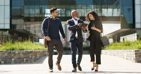 Image showing Walking, talking and business people with a tablet in the city for planning, meeting or discussion. Teamwork, corporate and employees speaking with technology for a strategy, internet or email