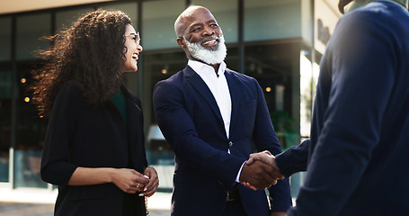 Image showing Handshake, welcome and happy business people in city by office for career, job and work opportunity. Professional, teamwork and workers shaking hands for agreement, thank you and b2b deal for success