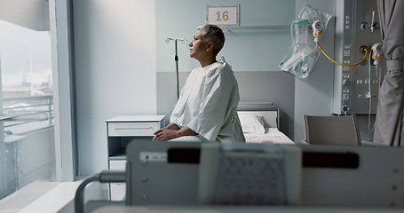 Image showing Sad, patient and thinking in hospital with window and stress, anxiety or fear of cancer, death and insurance. Senior, woman and depression in clinic with lady worried for future or mental health