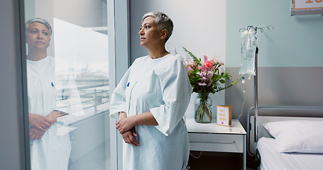 Image showing Sad, woman and thinking at window in hospital with stress, anxiety or fear of cancer, death or insurance. Senior, patient and depression in clinic with lady worried for future or mental health