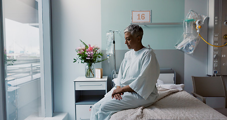 Image showing Sad, woman and thinking at window in hospital with stress, anxiety or fear of cancer, death or insurance. Senior, patient and depression in clinic with lady worried on bed for future or mental health