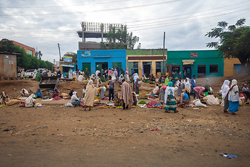 Image showing People engage in fruit trade on a dusty roadside street in Weretac, Ethiopia