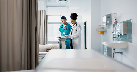 Image showing Doctor, team and nurse in discussion on tablet, planning and communication in hospital with bag. Technology, medical professional workers and people research healthcare online, wellness or telehealth