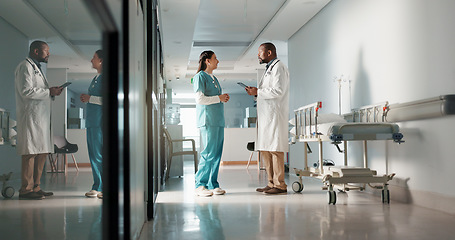 Image showing Doctors, man and woman in discussion, hallway and planning for surgery, advice or tablet in hospital. Medic, nurse and teamwork with chat, mentorship or brainstorming for medical innovation in clinic