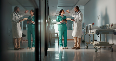 Image showing Doctors, man and woman in documents, corridor and planning for surgery, advice or tablet in hospital. Medic, nurse and teamwork with chat, mentorship or brainstorming for medical innovation in clinic