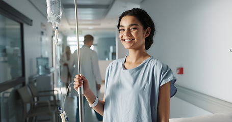 Image showing Iv drip, patient and portrait of happy woman in a hospital or clinic corridor with treatment for recovery from surgery. Intravenous, medicine and person with medical insurance for care and health