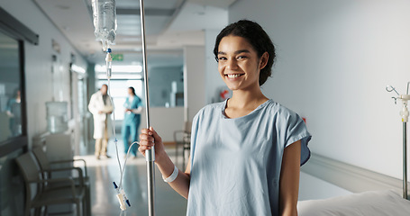 Image showing Iv drip, patient and portrait of happy woman in a hospital or clinic corridor with treatment for recovery from surgery. Intravenous, medicine and person with medical insurance for care and health