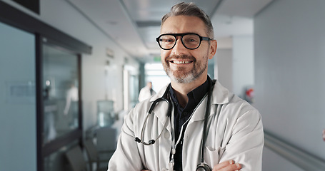 Image showing Doctor in portrait, senior man with arms crossed and healthcare, smile with confidence at hospital with pride and help. Medical professional, trust and happy at clinic with expert and stethoscope