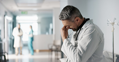 Image showing Stress, grief or fail with a mature doctor in a hospital looking unhappy for healthcare or medical. Depression, mistake or loss with a sad man medicine professional in a professional medicare clinic