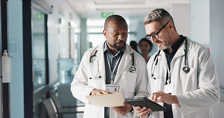 Image showing Doctors, teamwork and advice with documents, hospital folder and patient charts for healthcare planning or solution. Professional men with file, digital tablet and medical information or clinic data